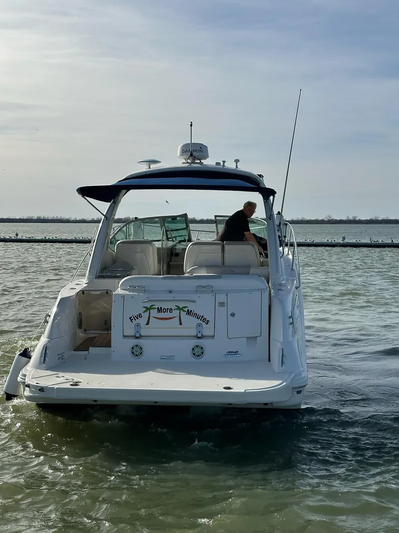 Slide: The Image of 2011 Sea Ray 350 Sundancer cruising on calm waters under a clear sky. - 5