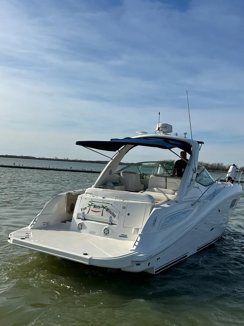 Slide: The Image of 2011 Sea Ray 350 Sundancer cruising on calm waters under a clear sky. - 6