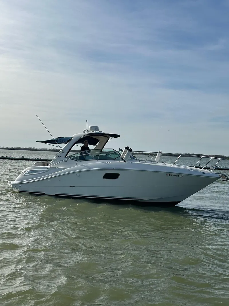 Slide: The Image of 2011 Sea Ray 350 Sundancer cruising on calm waters under a clear sky. - 7