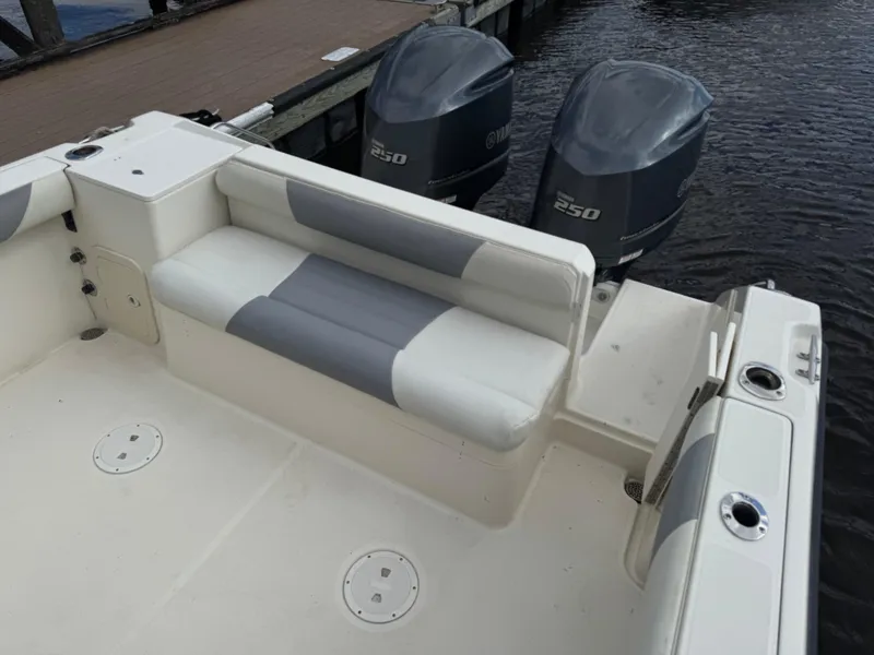 Slide: The Image of 1999 Pursuit 2870 Walkaround boat with dual 250 horsepower engines and cushioned seating. - 30