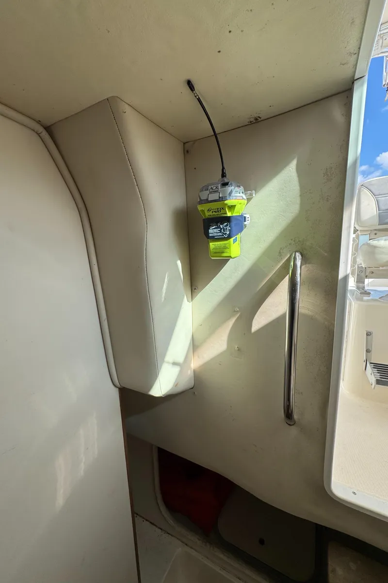 Slide: The Image of 1999 Pursuit 2870 Walkaround interior with mounted emergency radio beacon. - 34