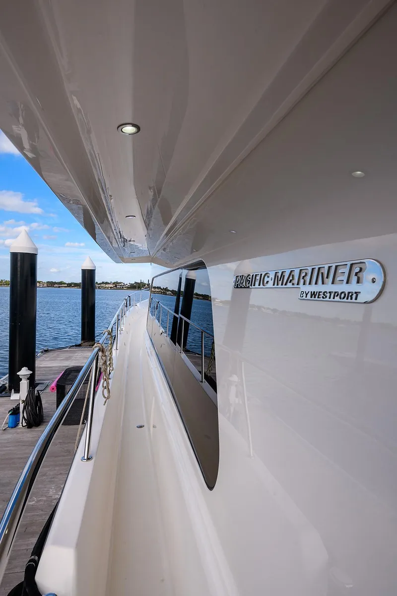 Slide: The Image of 2009 Pacific Mariner 85 yacht docked, showcasing sleek design and branding. - 10