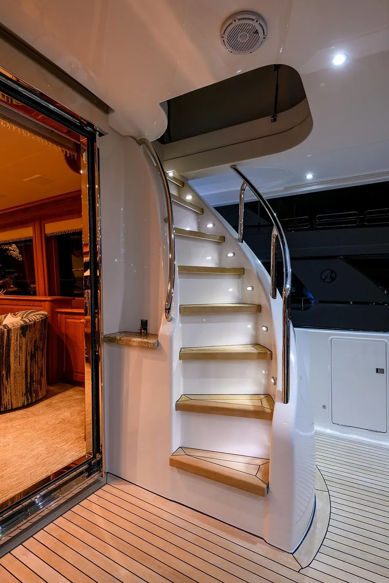 Slide: The Image of Elegant staircase on 2009 Pacific Mariner 85 yacht, featuring ambient lighting and sleek design. - 11