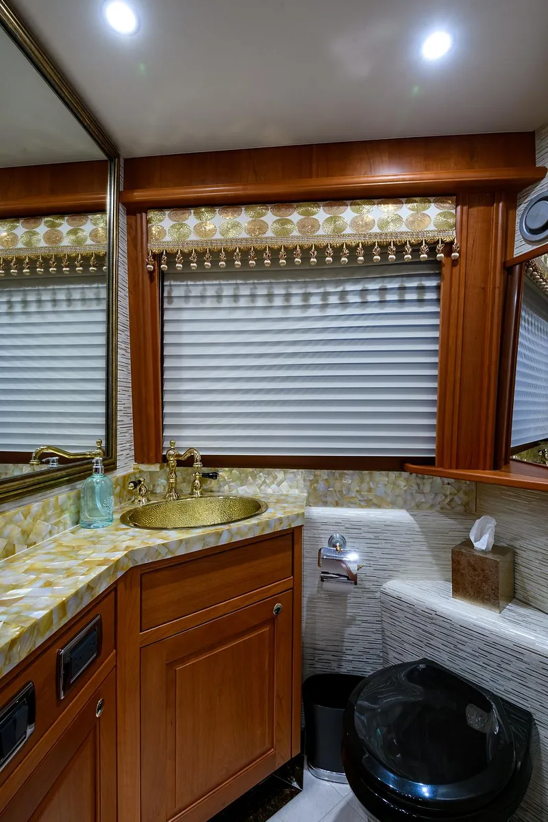 Slide: The Image of Luxurious bathroom in a 2009 Pacific Mariner 85 yacht with elegant wood cabinetry. - 28