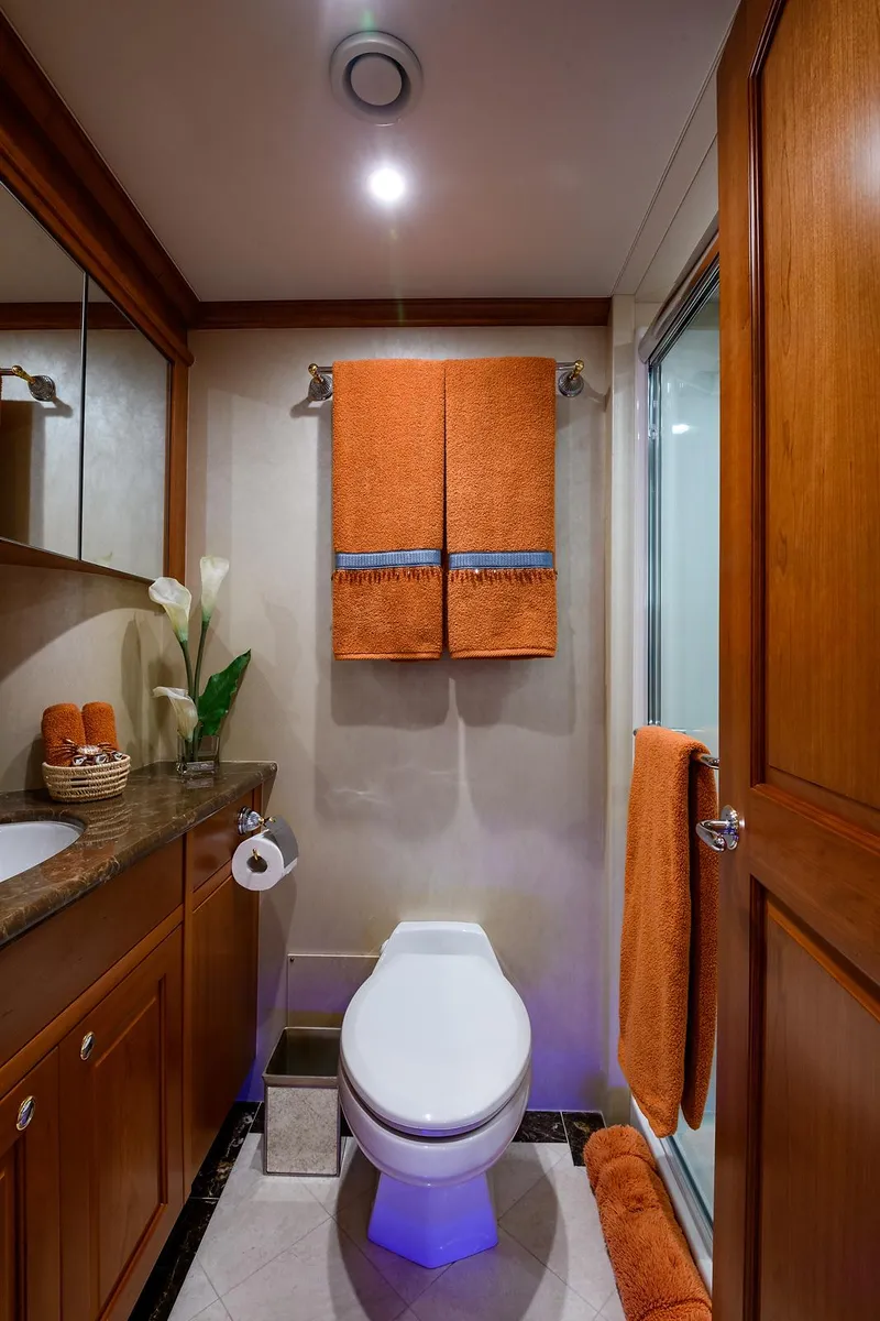 Slide: The Image of Luxurious bathroom in 2009 Pacific Mariner 85 yacht with modern fixtures and orange accents. - 31
