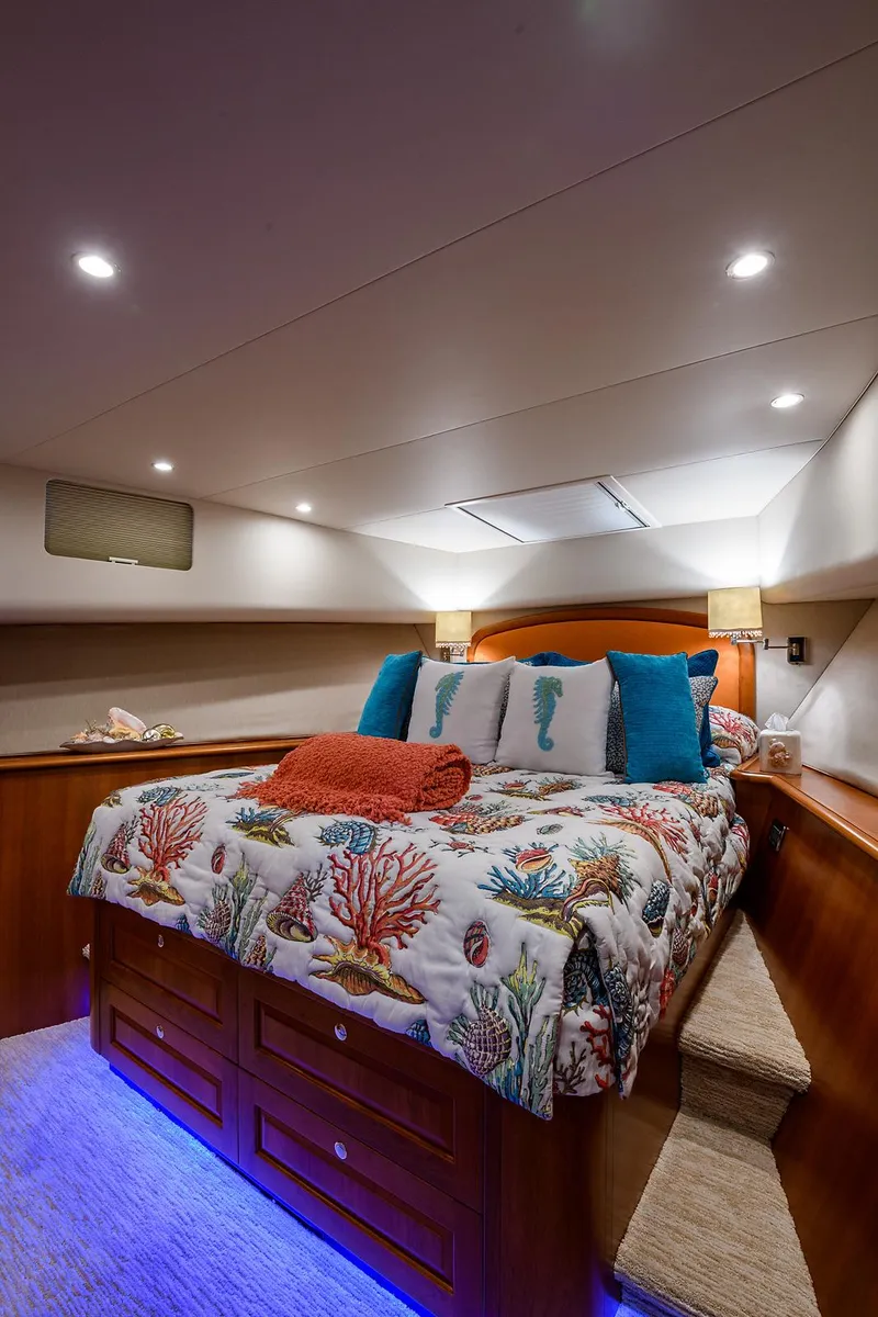 Slide: The Image of Luxurious bedroom in 2009 Pacific Mariner 85 yacht with vibrant bedding and ambient lighting. - 33