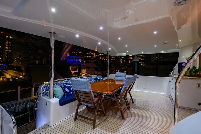 Slide: The Image of Luxurious 2009 Pacific Mariner 85 yacht deck with elegant dining area at night. - 4