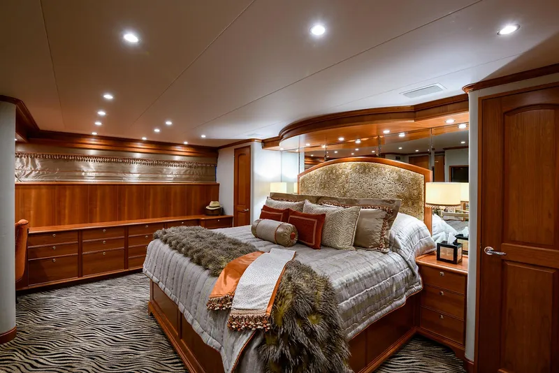 Slide: The Image of Luxurious bedroom interior on 2009 Pacific Mariner 85 yacht, featuring elegant wood finishes and plush bedding. - 44