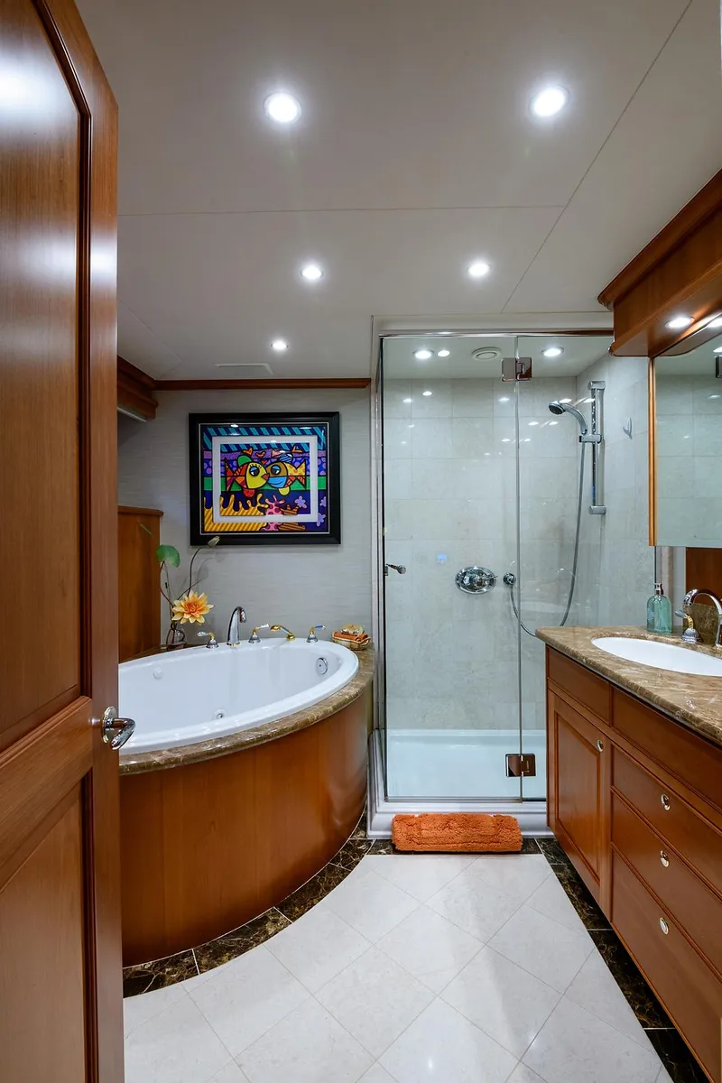 Slide: The Image of Luxurious bathroom in 2009 Pacific Mariner 85 yacht with tub, shower, and elegant wood finishes. - 46