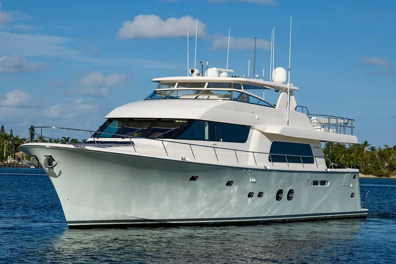 Slide: The Image of Luxury 2009 Pacific Mariner 85 yacht cruising on calm waters under a clear sky. - 67