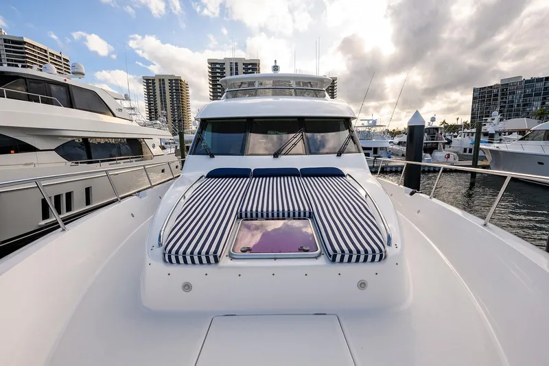 Slide: The Image of 2009 Pacific Mariner 85 yacht docked, featuring striped sun pads and modern design. - 9