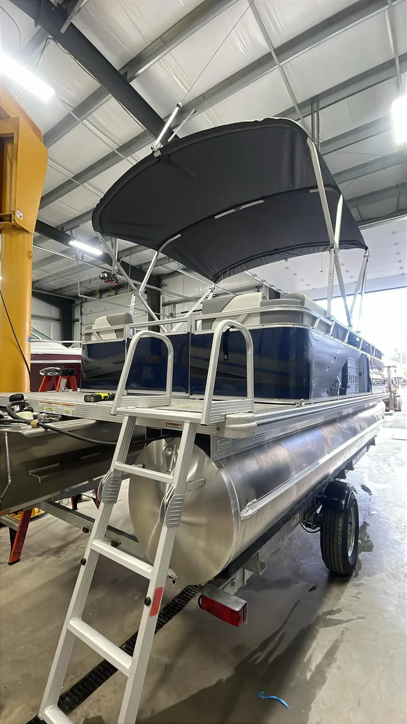 Slide: The Image of 2025 Tahoe Pontoon SP 1980 Quad Lounge with canopy in a warehouse setting. - 4