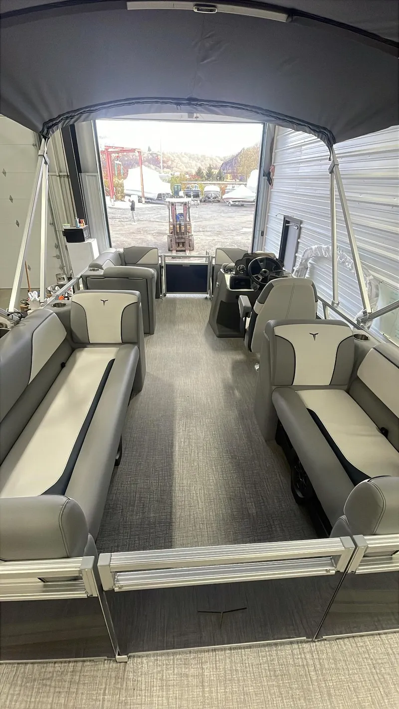 Slide: The Image of 2025 Tahoe Pontoon SP 1980 Quad Lounge interior with gray seating and canopy. - 5