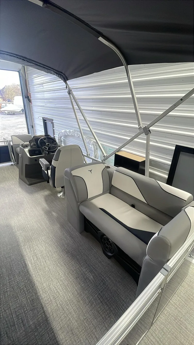 Slide: The Image of 2025 Tahoe Pontoon SP 1980 Quad Lounge interior with seating and helm. - 6