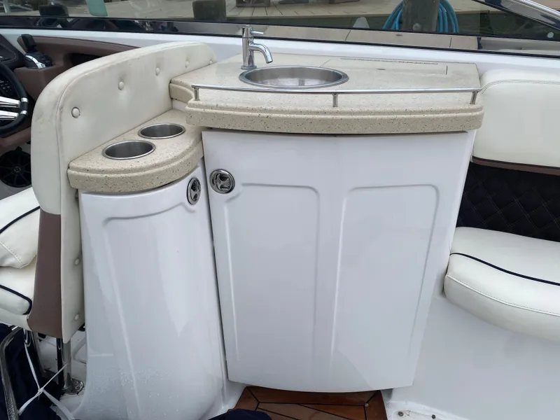 Slide: The Image of 2013 Cobalt 302 boat interior with sink and cup holders. - 13