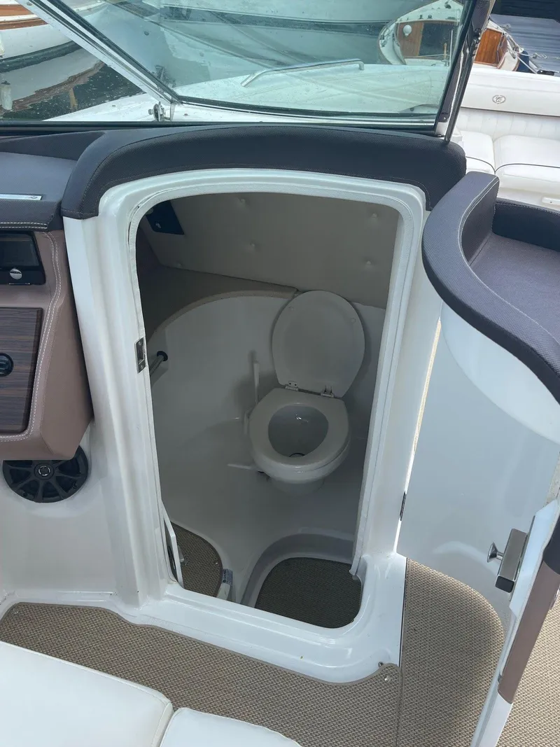 Slide: The Image of 2013 Cobalt 302 boat interior with compact marine toilet. - 17