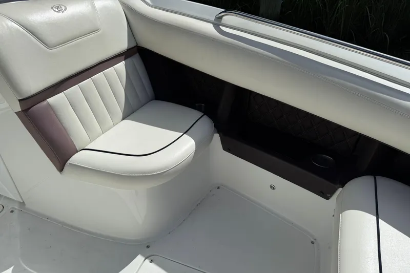 Slide: The Image of Luxurious seating in 2013 Cobalt 302 boat, featuring elegant white and brown upholstery. - 21
