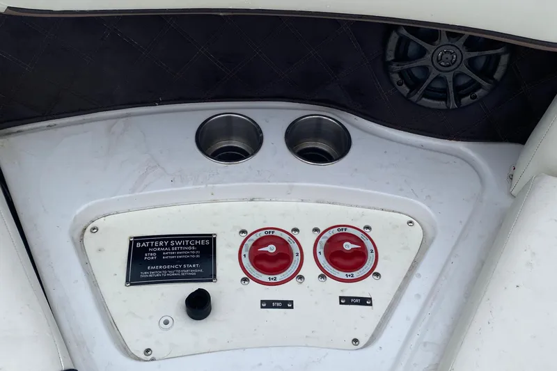 Slide: The Image of Control panel of a 2013 Cobalt 302 boat with battery switches and cup holders. - 26