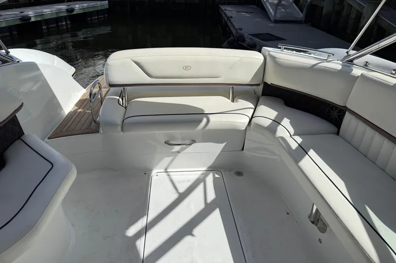 Slide: The Image of Luxurious seating area on a 2013 Cobalt 302 boat, featuring white upholstery. - 9