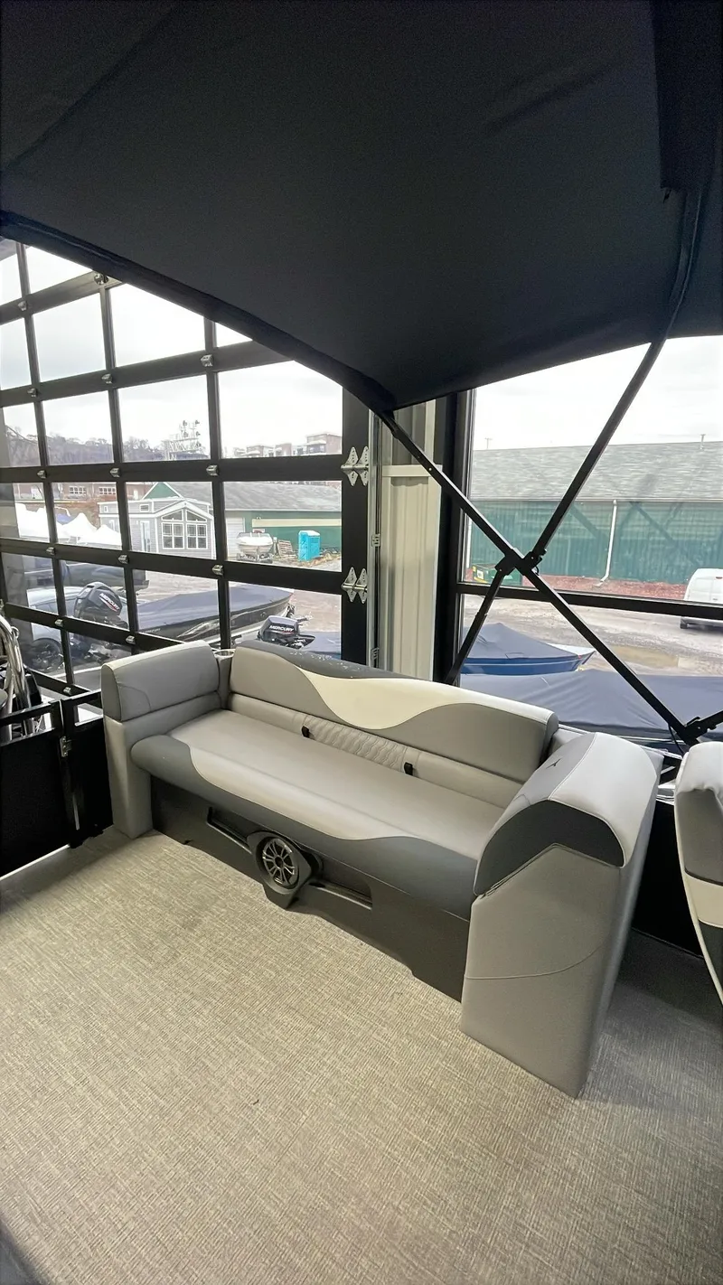 Slide: The Image of 2025 Tahoe Pontoon SP 2385 QL interior with modern seating and spacious design. - 13