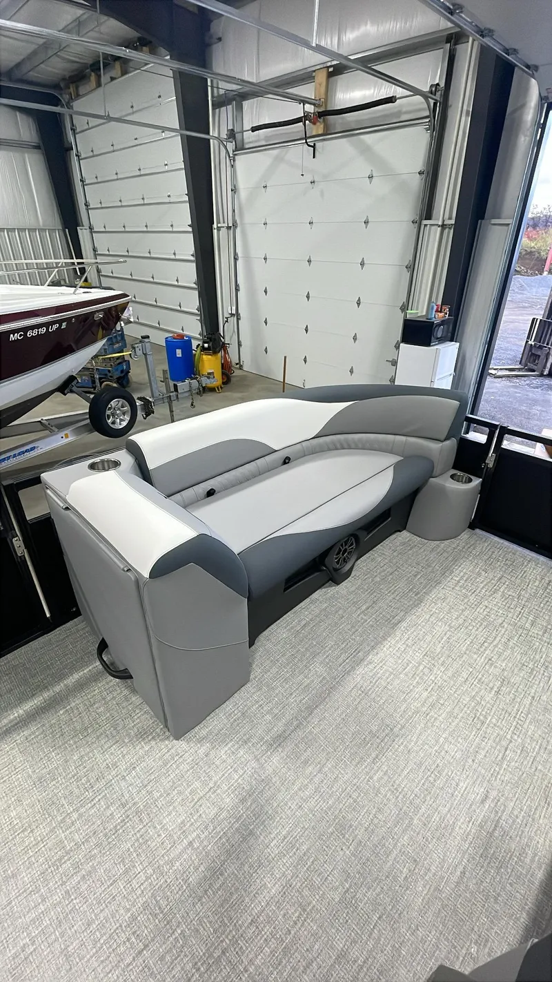 Slide: The Image of 2025 Tahoe Pontoon SP 2385 QL interior in a showroom setting. - 15