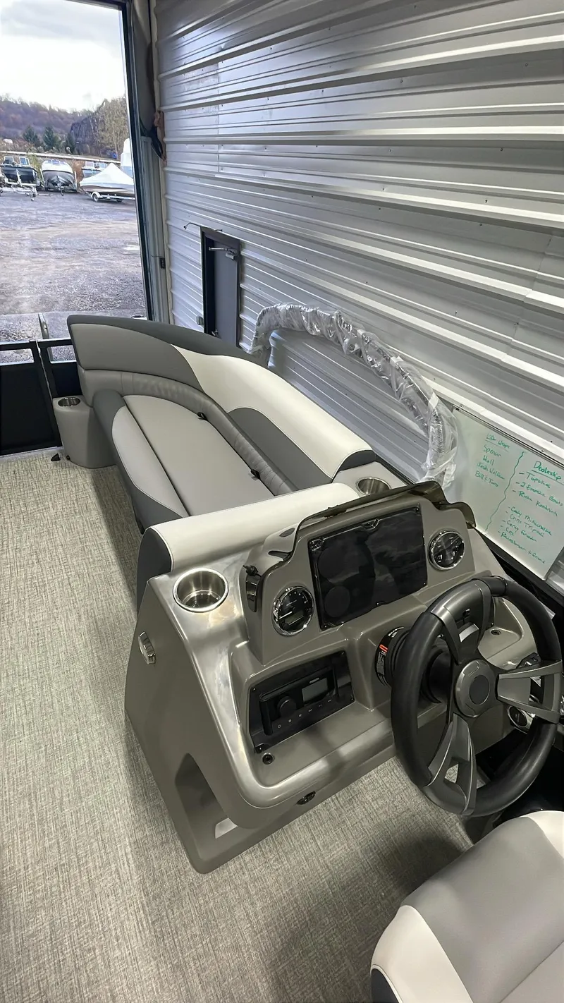 Slide: The Image of 2025 Tahoe Pontoon SP 2385 QL interior with modern dashboard and seating. - 16