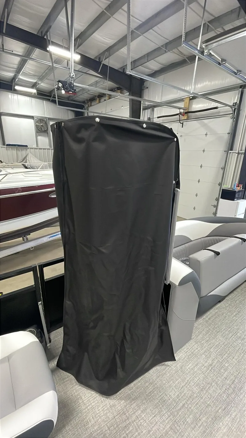 Slide: The Image of 2025 Tahoe Pontoon SP 2385 QL interior with black cover in a showroom. - 18