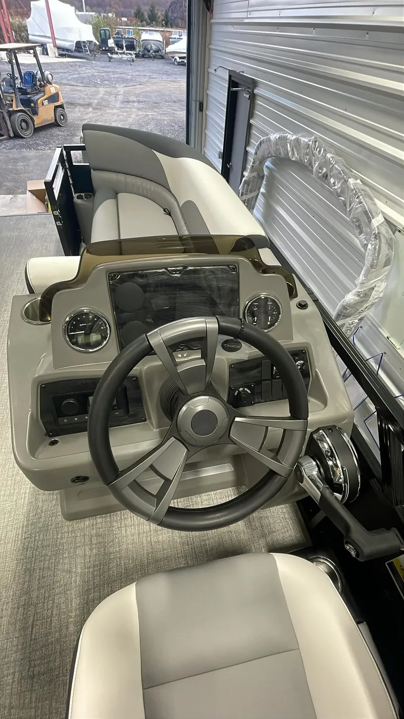 Slide: The Image of 2025 Tahoe Pontoon SP 2385 QL steering console with modern controls and sleek design. - 19