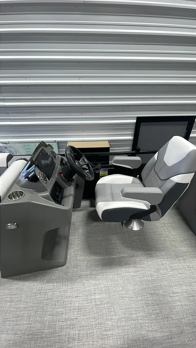 Slide: The Image of 2025 Tahoe Pontoon SP 2385 QL cockpit with modern steering and seating. - 20