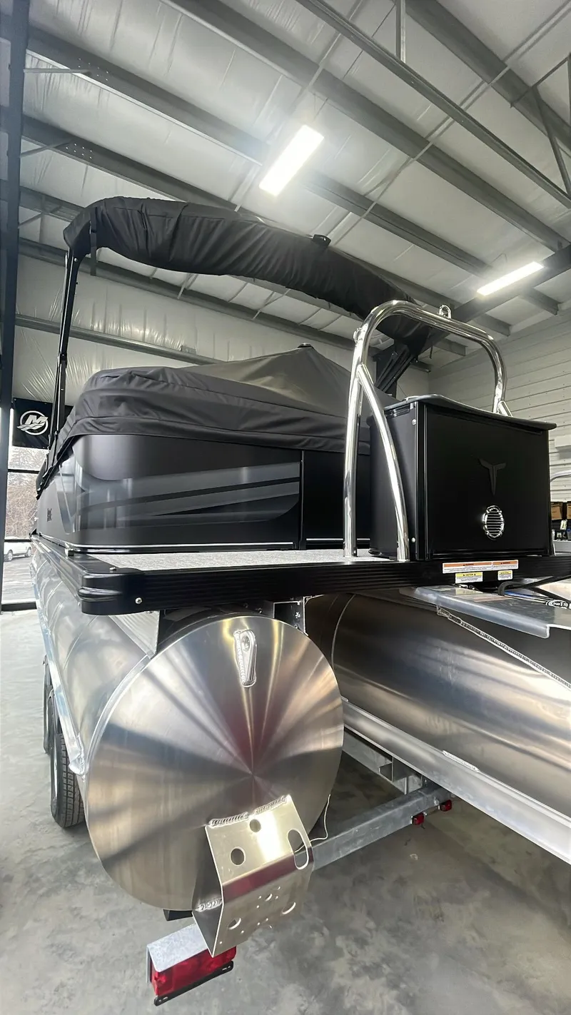 Slide: The Image of 2025 Tahoe Pontoon SP 2385 QL in a showroom, showcasing sleek design and modern features. - 3