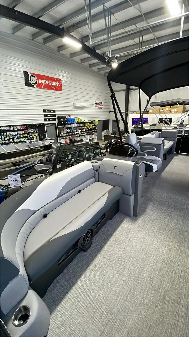 Slide: The Image of 2025 Tahoe Pontoon SP 2385 QL interior with modern seating in showroom. - 6