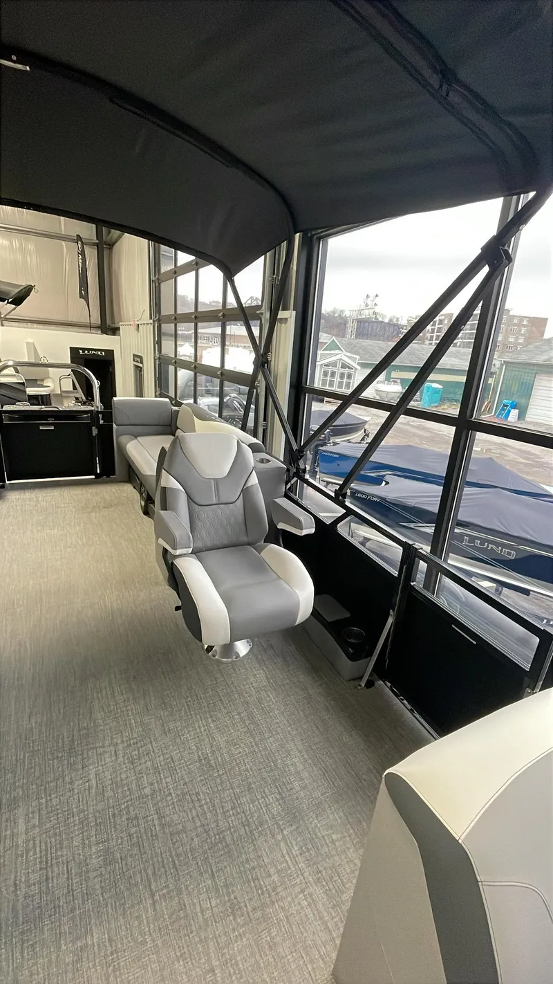 Slide: The Image of 2025 Tahoe Pontoon SP 2385 QL interior with modern seating and panoramic windows. - 9