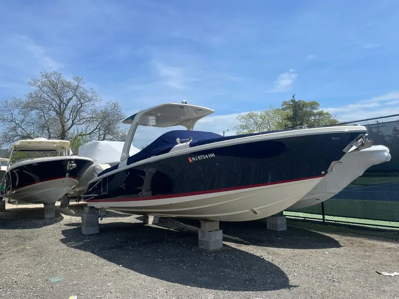 The Image of 2020 Chris-Craft Launch 28GT boat on display, blue hull, sunny day, outdoor setting. - 0