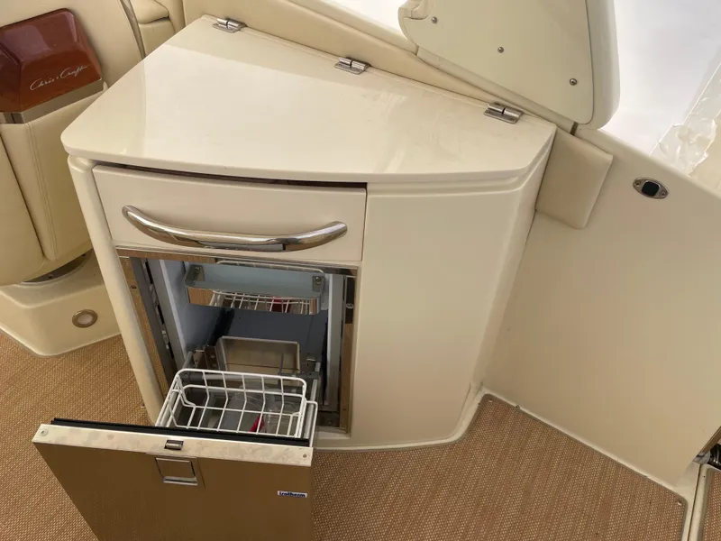 Slide: The Image of 2020 Chris-Craft Launch 28GT boat interior with open mini fridge. - 12