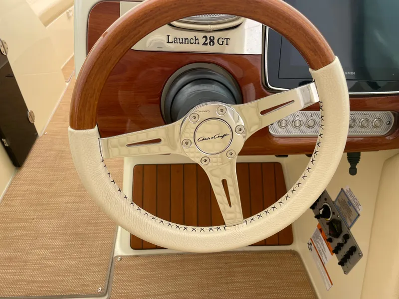 Slide: The Image of 2020 Chris-Craft Launch 28GT steering wheel with wood and leather accents. - 17