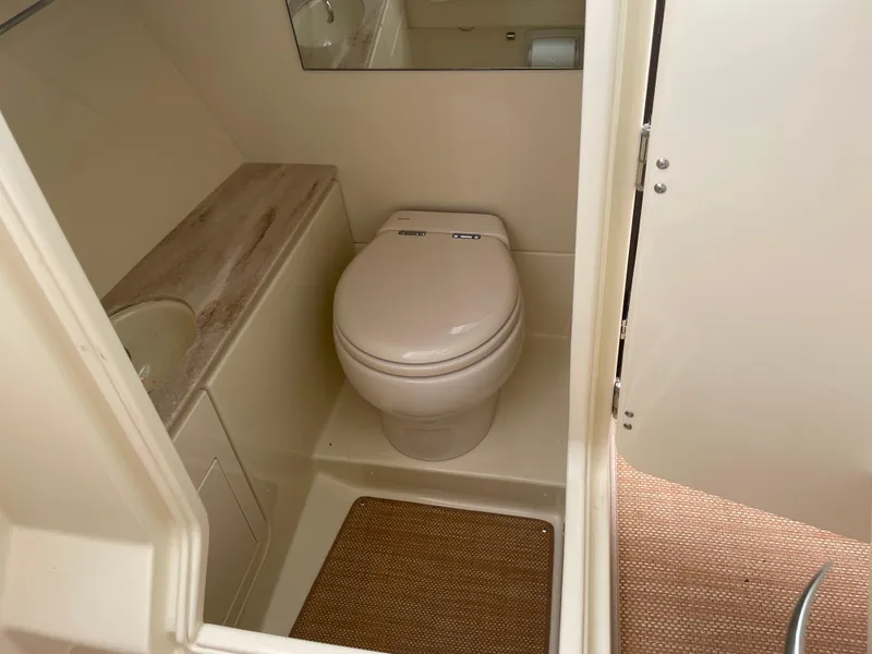 Slide: The Image of 2020 Chris-Craft Launch 28GT boat bathroom interior with toilet and sink. - 22