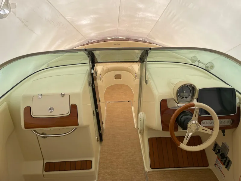 Slide: The Image of 2020 Chris-Craft Launch 28GT cockpit with elegant wood accents and modern steering wheel. - 25