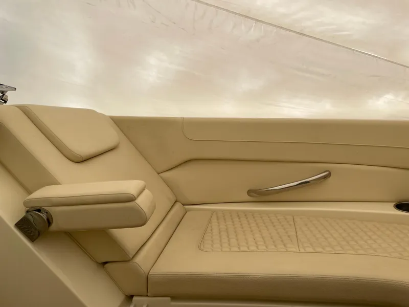 Slide: The Image of 2020 Chris-Craft Launch 28GT interior with beige leather seating and armrest. - 28