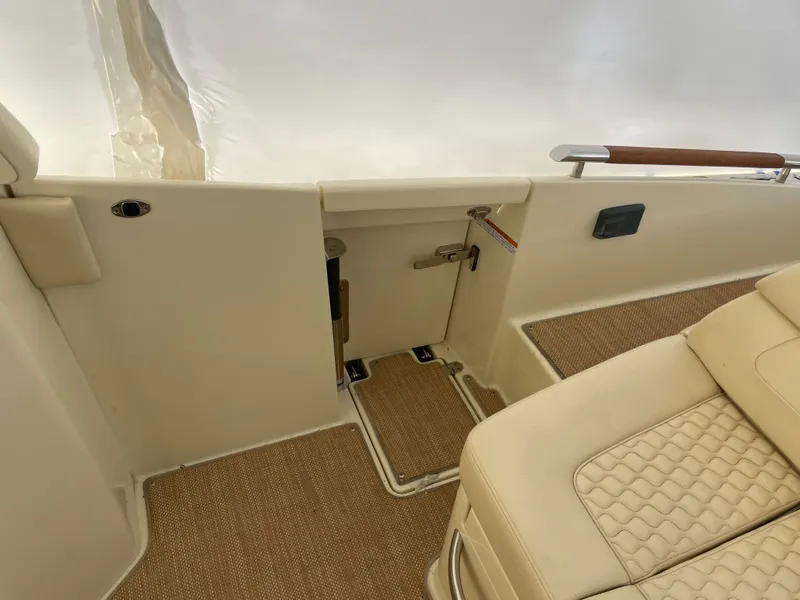 Slide: The Image of Interior of 2020 Chris-Craft Launch 28GT, featuring beige seating and carpeted flooring. - 5