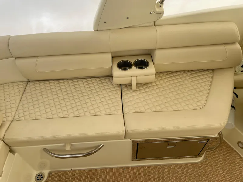 Slide: The Image of 2020 Chris-Craft Launch 28GT boat interior with beige quilted seating and cup holders. - 8