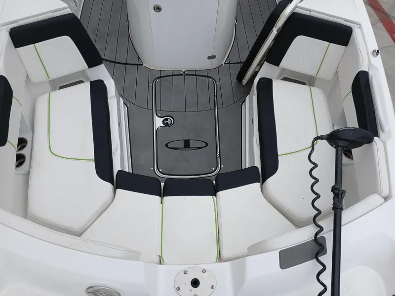 Slide: The Image of 2023 Tahoe 2150 CC boat interior with white and black seating, modern design. - 11