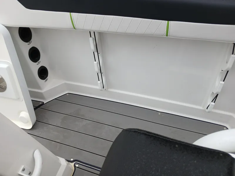 Slide: The Image of 2023 Tahoe 2150 CC boat interior with gray flooring and storage compartments. - 12