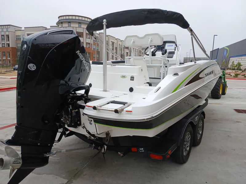 Slide: The Image of 2023 Tahoe 2150 CC boat on trailer, featuring sleek design and powerful outboard motor. - 2