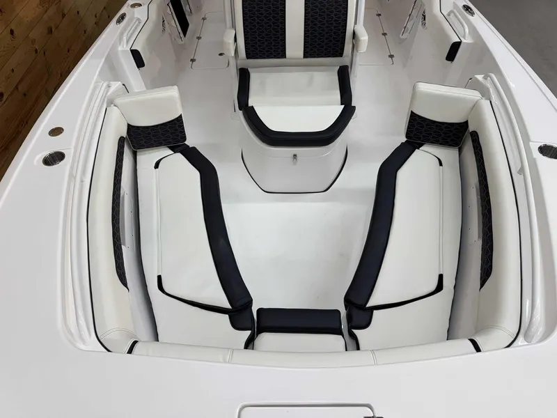 Slide: The Image of 2025 Tidewater 256 CC Adventure boat interior with sleek white and black seating. - 13