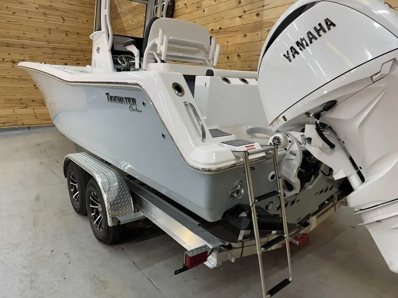 Slide: The Image of 2025 Tidewater 256 CC Adventure boat with Yamaha engine on a trailer. - 2