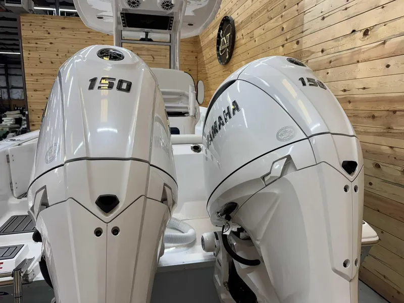 Slide: The Image of 2025 Tidewater 256 CC Adventure with dual 150 horsepower engines in a wooden interior setting. - 3