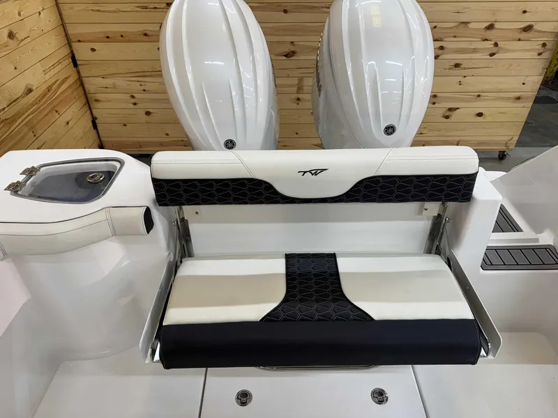 Slide: The Image of 2025 Tidewater 256 CC Adventure boat interior with dual engines and seating. - 8