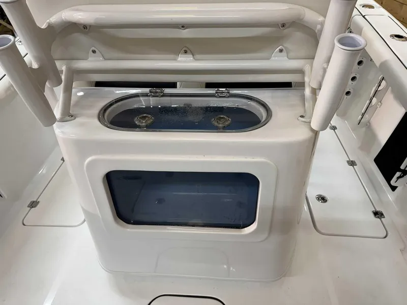 Slide: The Image of 2025 Tidewater 256 CC Adventure boat livewell and rod holders on deck. - 9