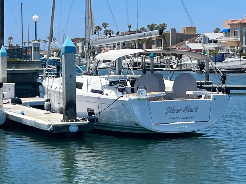 The Image of 2021 Hanse 418 sailboat docked in a marina under clear blue skies. - 12