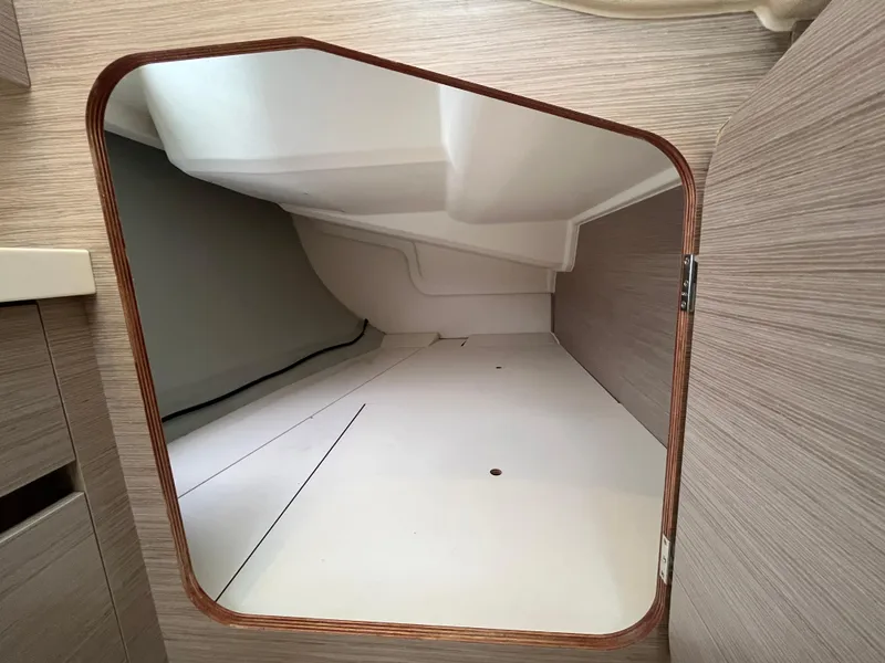 Slide: The Image of Interior storage compartment of a 2021 Hanse 418 yacht, featuring sleek wooden finish. - 18